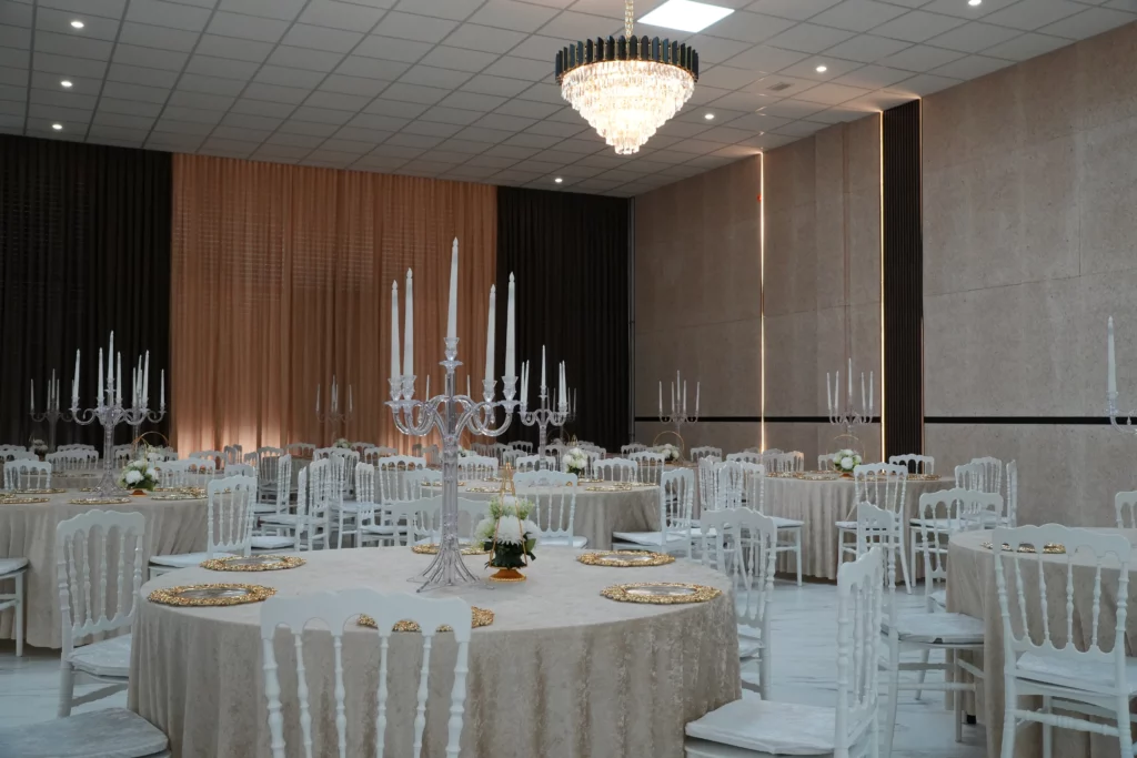 Intimate wedding hall setup with crystal candelabras, gold charger plates and warm ambient lighting at AWA Zug venue near Zug Switzerland